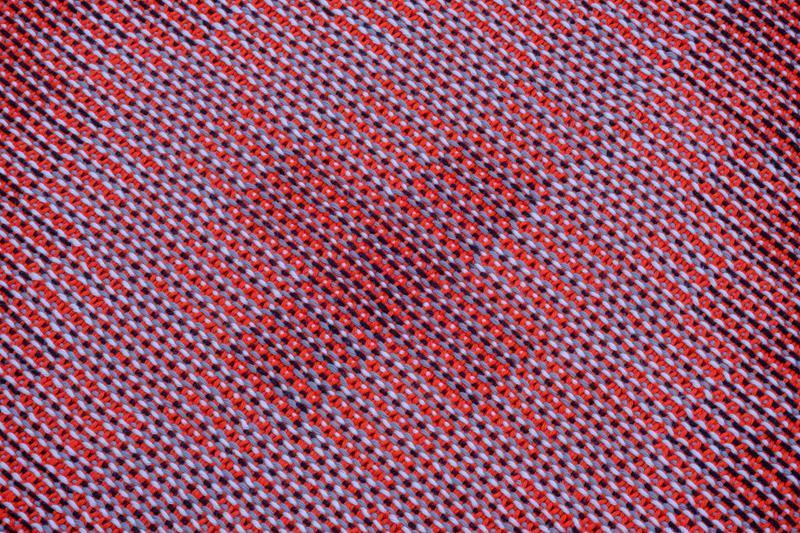 Close-up shot of the red handwoven towel in cotton yarn using the corris effect