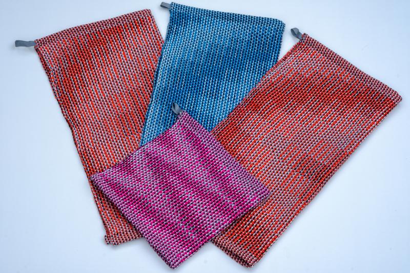 Overview shot of the four handwoven towels in cotton yarn using the corris effect