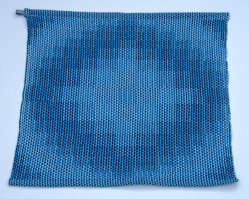 Handwoven turquoise towel in cotton yarn using the corris effect shown from above