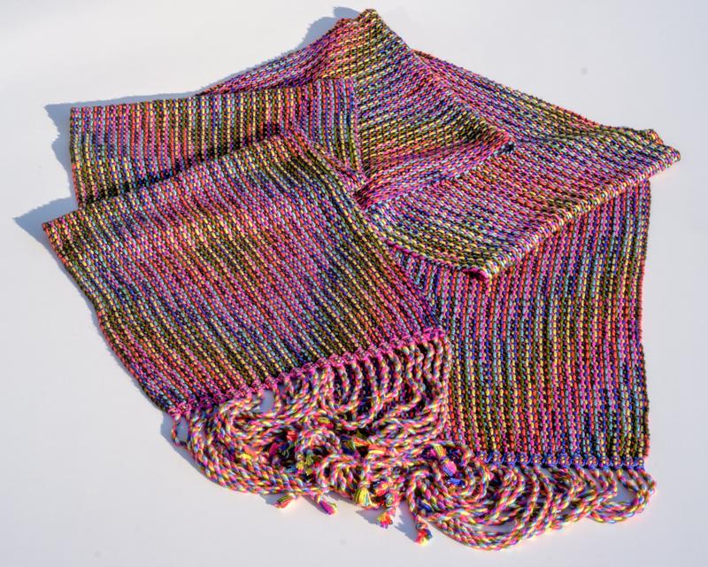 Overview shot of a handwoven shawl in a multi-color Corris pattern