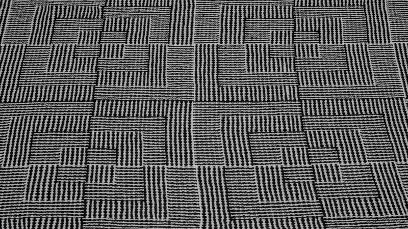 Pattern inspired by nested squares executed in black & white yarn