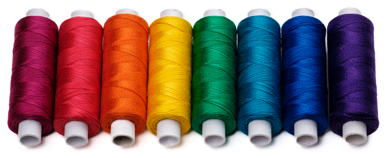 Eight mini spools of Ne 20/2 cotton yarn in rainbow colors