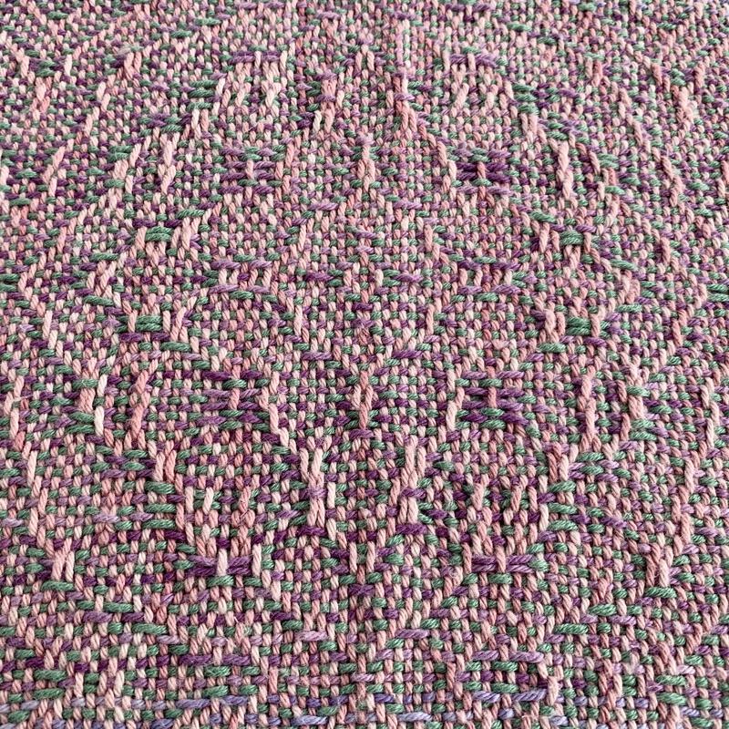 Woven towel with green and lilac weft