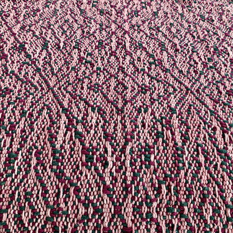 Woven towel with green and purple weft