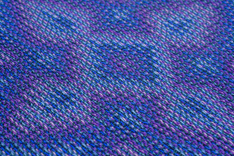 Close-up of the heart of a flower-like pattern woven in crochet cotton.