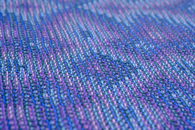 Close-up of one repeat of a flower-like pattern woven in echo technique
