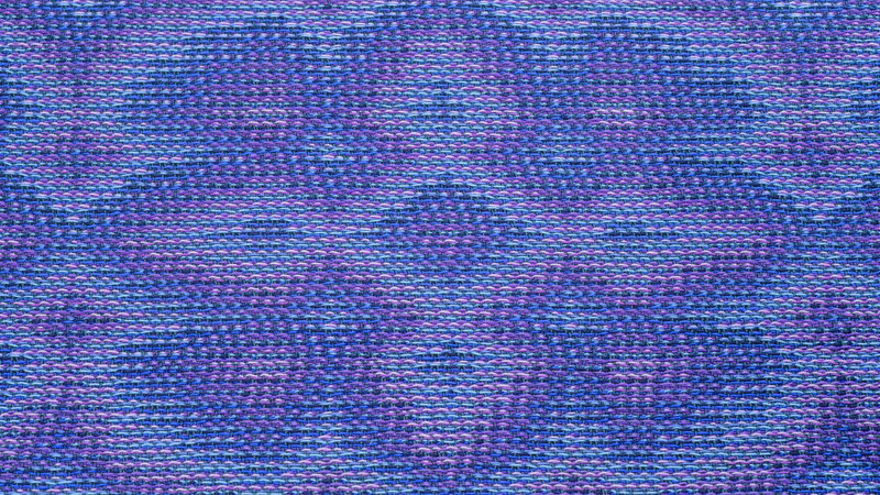 One pattern repeat of a flower woven in echo-8 using shades of blue and purple