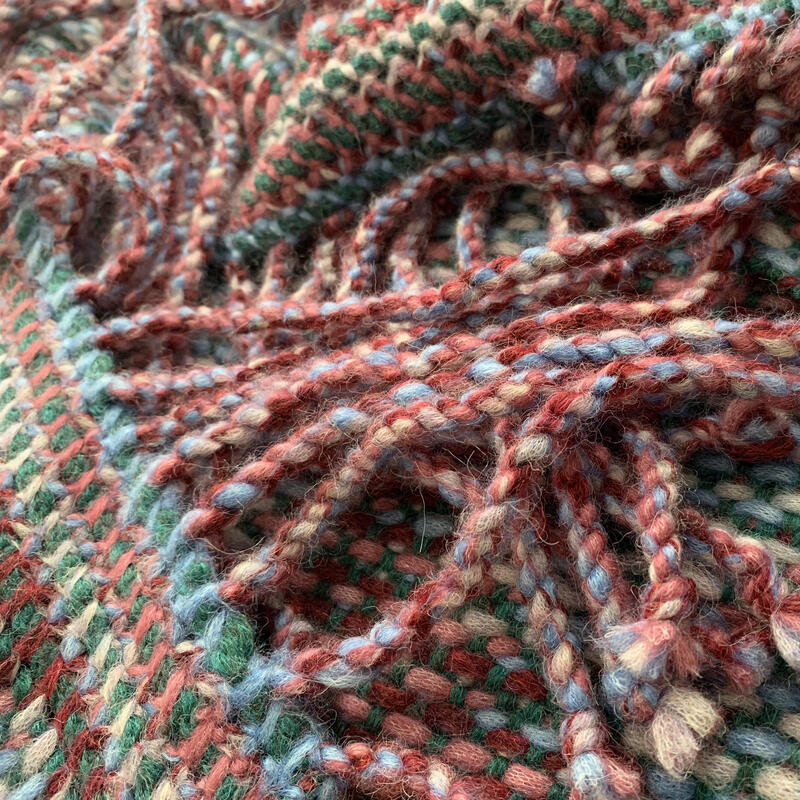 Twisted fringes covering the shawl