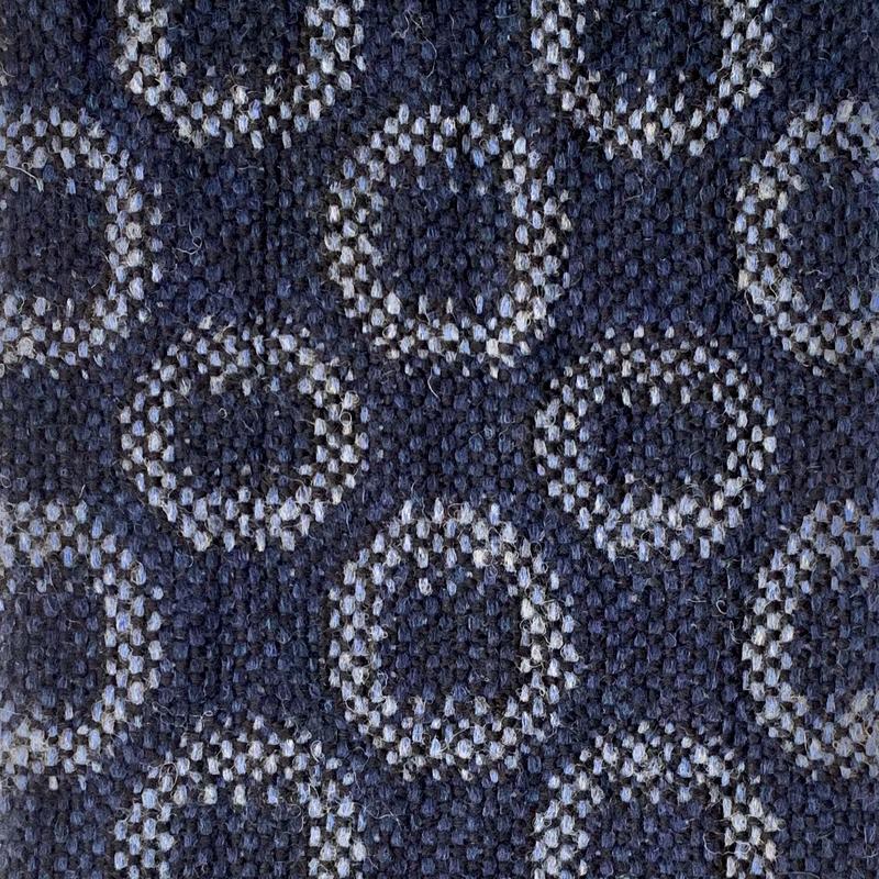 Close-up of turned taquete circles in light blue on dark blue background