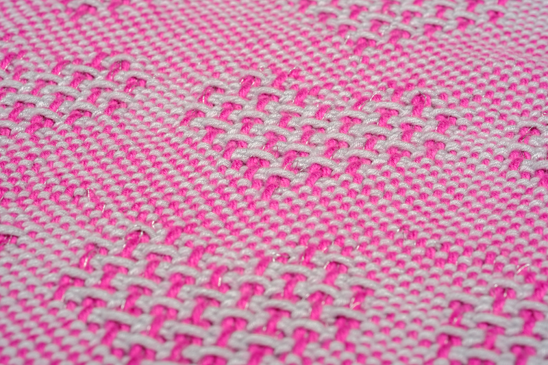 Close-up of shawl with pink and silver hearts