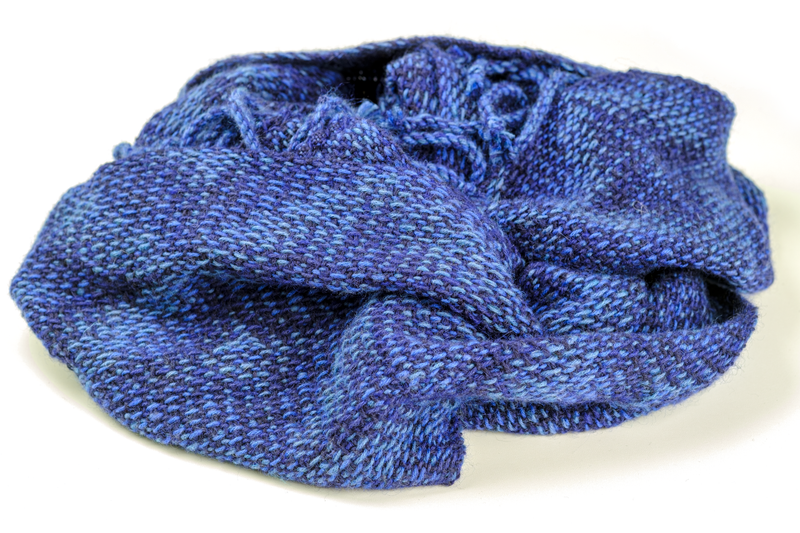 Shawl woven using a monochrome variant of the Corris-effect in shades of blue, thrown in a bunch