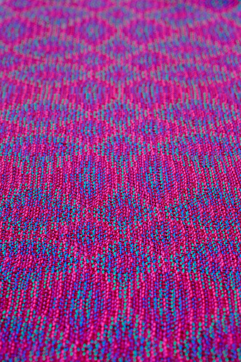 Shot of a handwoven shawl in echo weave showing the full pattern at a steep angle