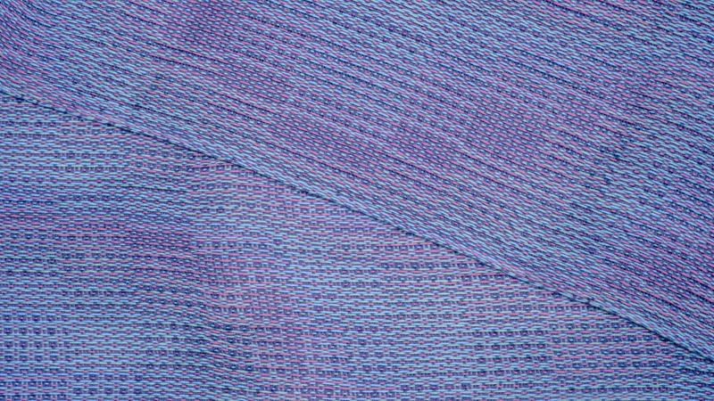 Close-up shot from above of a handwoven shawl in lyocell yarn using the Corris effect