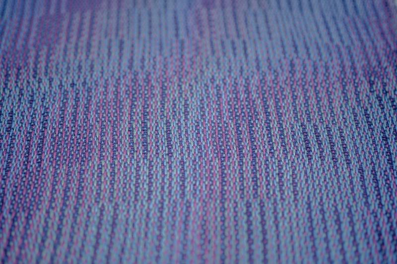 Close-up shot from a low angle of a handwoven shawl in lyocell yarn using the Corris effect