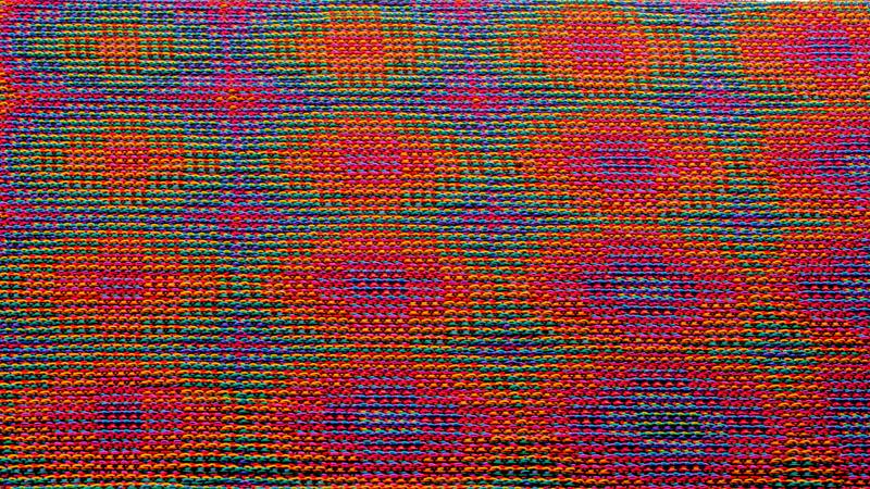 One pattern repeat of a shawl in rainbow colors using the echo-4 technique with 8 advancing circles