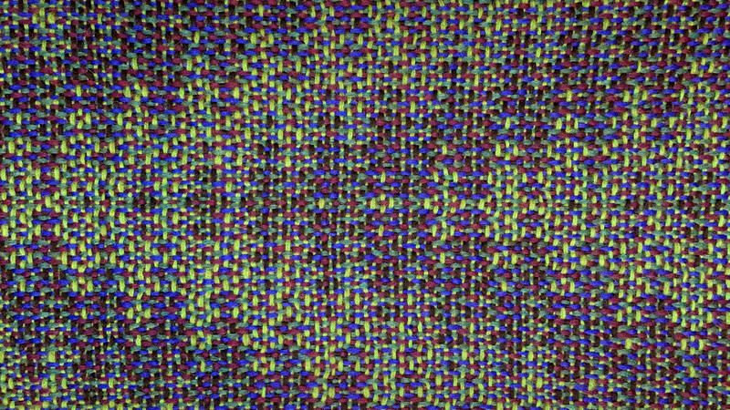 Shawl in shades of green pointing left.